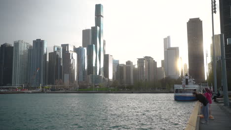 Tourists-by-Lake-Michigan-at-Navy-Pier,-on-a-windy-day-in-Chicago