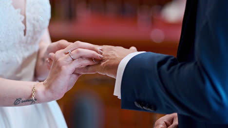 Close-up-shot-of-unrecognizable-couple-getting-married,-rings-exchange