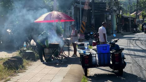 Street-Vendor-Cooking-Street-Food-at-Stall-at-Choeng-Mon-Beach-in-Koh-Samui,-Thailand