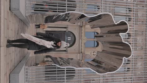 Woman-Posing-In-The-Ai-Weiwei-Cage-like-Arch-Sculpture-Aims-To-Promote-A-world-Without-Borders-Outside-The-National-Museum-Gallery-In-Stockholm,-Sweden