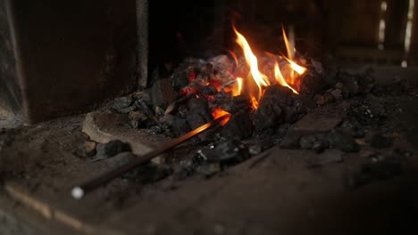 A-blacksmith-reenactor-brings-history-to-life-by-portraying-a-traditional-blacksmith,-showcasing-the-art-and-trade-of-metalworking-with-authentic-tools-and-methods