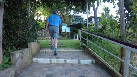 An-American-citizen-walking-through-the-garden-and-taking-pictures-of-the-areas-of-Jomax-Peak-in-Don-Salvador-Benedicto,-Negros-Occidental,-Philippines