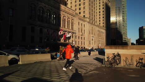 Wide-establishing-shot-of-pedestrians-walking-outside-the-Fairmont-Royal-York-Hotel-in-Toronto