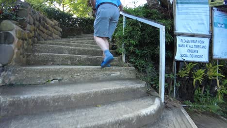 An-American-citizen-walking-upstairs-of-the-garden-of-Jomax-Peak-in-Don-Salvador-Benedicto,-Negros-Occidental,-Philippines