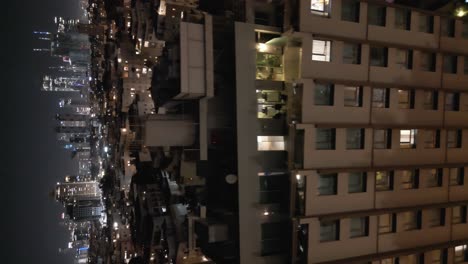 Tilt-view-of-Tel-Aviv-night-aerial-panorama-modern-glass-skyscrapers-illuminating-in-the-dark