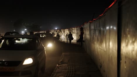 Busy-Traffic-at-Night-in-New-Delhi-India,-people-walking-and-waiting