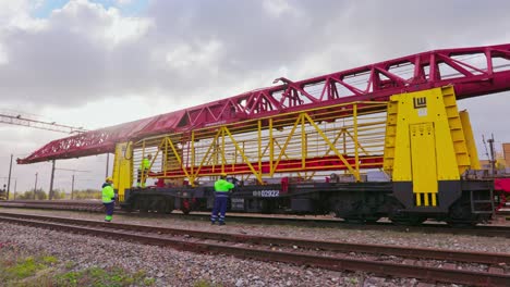 railway-railroad-construction-workers-operate-machinery,-wide-shot,-static