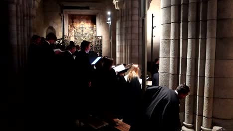 Unrecognizable-group-of-tuna-singing-inside-Porto-Cathedral-following-director-instructions