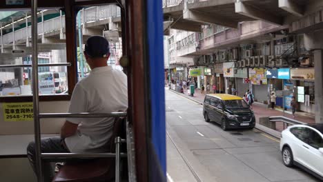 A-man-riding-the-tram-sitting-at-the-front