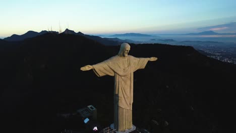 Vista-Aérea-Lejos-De-La-Estatua-Del-Cristo-Redentor,-Puesta-De-Sol-En-Río,-Brasil---Retroceso,-Disparo-De-Drone