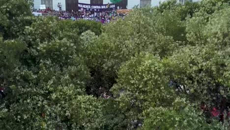 Going-up-to-a-wide-view-of-protesters-against-Bolsonaro-in-the-center-of-Rio-de-Janeiro,-Brazil