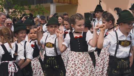 Children-Dancing-In-Traditional-Bavarian-Clothes,-Lederhose-And-Dirndl-At-Maibaumaufstellen