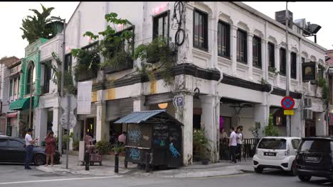 People-chatting-outside-the-restaurant-in-Chinatown,-Kuala-Lumpur,-Malaysia