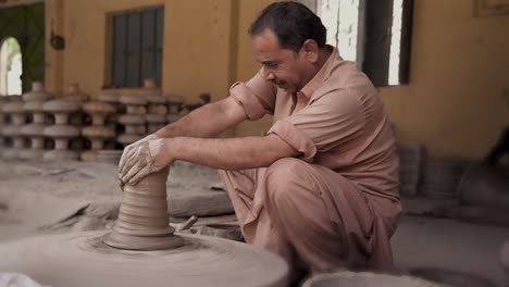 Artesano-Dando-Forma-A-La-Arcilla-En-Un-Torno-De-Alfarero,-Elaborando-Hermosas-Cerámicas.