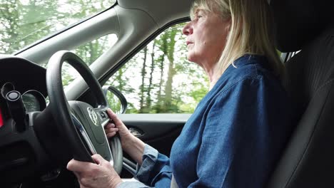 Femail-English-driver-driving-her-right-hand-car-carefully-on-a-UK-road-during-a-bright-day