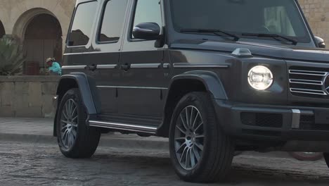 Close-up-of-a-classic-G-class-Mercedes-Benz-parked-in-middle-of-street