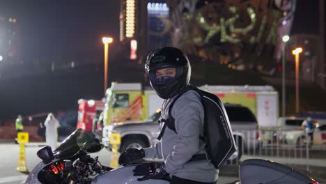 A-man-on-a-motorcycle-signing-a-thumbs-up