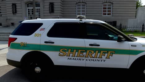 Maury-County-Sheriff-car-in-Columbia,-Tennessee-with-gimbal-video-walking-around