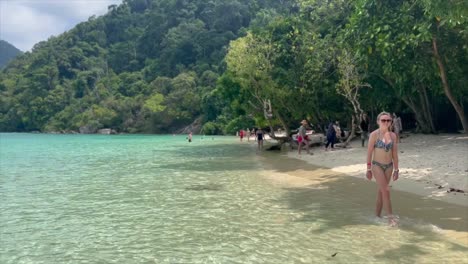 European-tourist-walking-along-Thai-beach-in-island-paradise