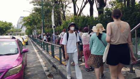 Walking-Shot-at-the-Entrance-of-the-Famous-Chatuchak-Market-in-Bangkok-With-Locals-and-Foreigners-Walking,-Thailand