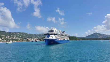 A-modern-luxury-cruise-ship-moving-against-beautiful-Caribbean-island-in-background-|-Cruise-ship-in-Caribbean-island-Cinematic-view-commercial-video-background