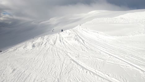 Offpiste-skier-going-from-prepped-slopes-to-fresh-untouched-snow-in-Myrkdalen-mountains-Norway---First-person-view-body-mounted-camera