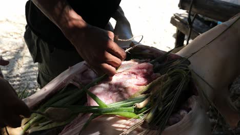 April-22,-2023-Danao-City,-Cebu,-Philippines---A-Man-is-Spicing-Up-a-Lechon-Baboy-or-Suckling-Pig-Preparing-it-to-be-Roasted-over-Fire