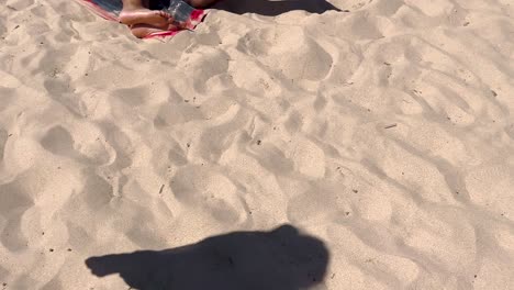 close-view-of-fit-and-attractive-Couple-lying-on-the-beach-in-cascais-beaches