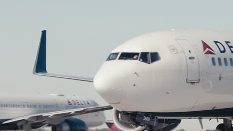 Close-up-of-a-Delta-commercial-airplane-taxing-down-a-runway-at-ATL-airport-in-Atlanta-Georgia