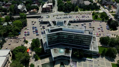 Hamilton-Ontario-City-Hall-Drone-aerial-4k60-overlooking-downtown-front-of-the-building-to-the-left-side-with-sparkling-fountain-on-a-sunny-summer-day-with-lush-green-parks-around-it