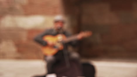 Person-Taking-Photos-with-Smart-Phone-of-Street-Musician-Playing-Guitar-in-Barcelona,-Spain