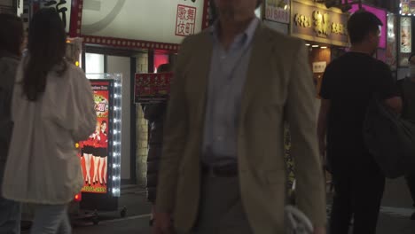 Women-Holding-Menus-Outside-In-Kabukicho-District-In-Shinjuku-At-Night