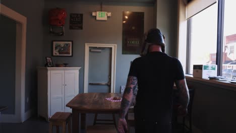 Burly-Man-And-Woman-Walking-Through-Coffee-Shop-Small-Town