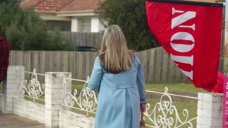 Female-Real-Estate-Agent-Rings-Bell-Before-House-Auction,-SLOW-MOTION