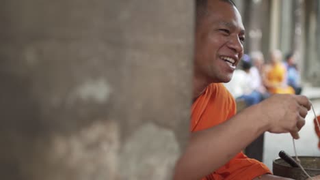 A-buddhist-monk-performing-blessing-ritual-ceremony-at-Angkor-Wat---Siem-Reap,-Cambodia-2