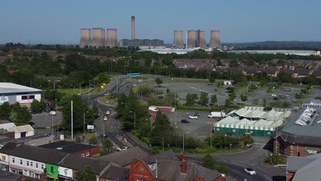 Aerial-view-above-small-town-power-station-and-market-street-retail-shops-rooftops-during-recession