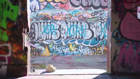 The-Camera-Tilts-Up-Through-the-Entry-Way-of-an-Abandoned-Bright-Colored-Spray-Painted-Tagged-Graffiti-Covered-Cement-Art-Building-in-Banff-Alberta-Canada