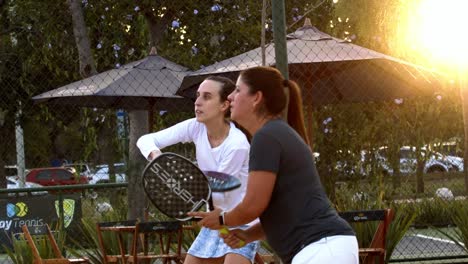 Two-women-focused-playing-beach-tennis-in-Brazil-at-sunset