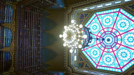 Truck-right-vertical-view-of-the-giant-upper-stained-glass-window-of-the-Royal-Portuguese-Reading-Room-in-Rio-de-Janeiro,-Brazil