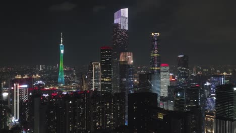 Distant-view-of-Guangzhou-beautifully-illuminated-Central-buildings-downtown-area-from-neighboring-living-apartment-block-at-night