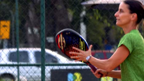 Woman-hitting-ball-with-racket-in-beach-tennis-sport-in-Brazil