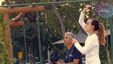 Slow-motion-close-up-of-father-and-daughter-playing-beach-tennis-together