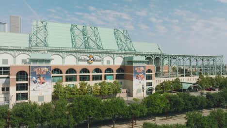 Aerial-drone-view-panning-right-to-left-of-the-right-field,-home-plate,-and-clock-tower-entrances-to-Minute-Maid-Park,-home-of-the-Houston-Astros,-in-Houston-Texas