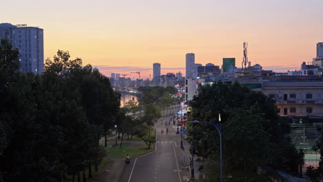 Evening-cityscape-of-Saigon-with-highway-traffic,-featuring-a-beautiful-landscape-of-buildings-and-trees