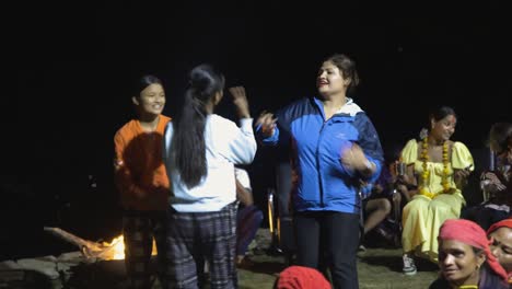 Young-Nepali-woman-dancing-celebrating-by-fire