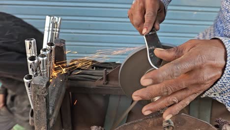 An-artist-is-sharpening-a-knife-using-the-traditional-method