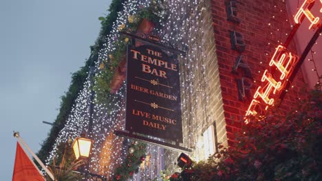 Dublin,-Ireland---The-Sign-at-the-Temple-Bar-Entrance-During-the-Onset-of-Dusk---Low-Angle-Shot