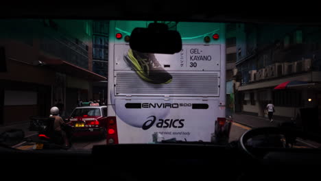 Perspective-view-from-driver-inside-of-a-mini-bus-driving-on-the-road-in-Hong-Kong,-China