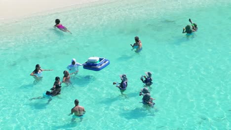 Drone-shot-of-revelers-at-Bay-Las-Aguilas-in-Pedernales,-Dominican-Republic