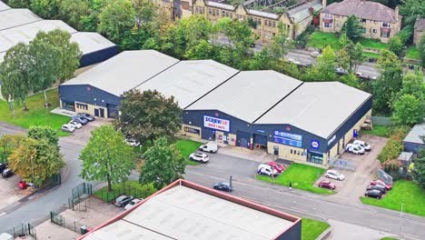 Hardware-store-front,-Screwfix-Huddersfield,-Birkby,-sunny-drone-overview-aerial-shot